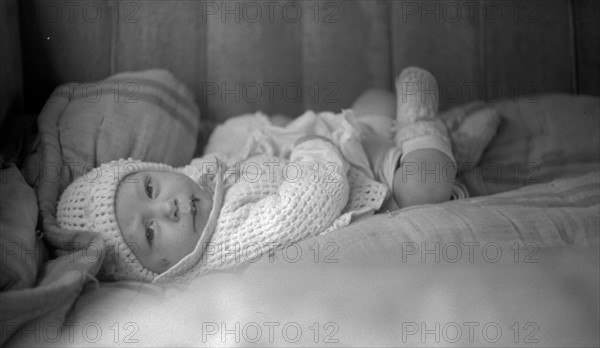 Baby in back seat of migrant workers' automobile