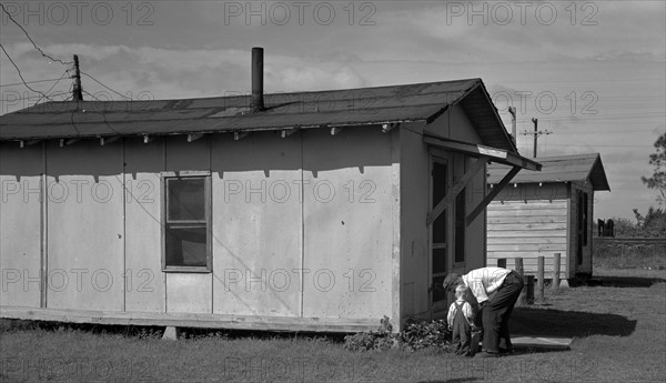 camp used by migrant citrus workers. Some migrants cannot afford to rent such houses, and live in tents or crude homemade trailers. Winterhaven, Florida 19370101