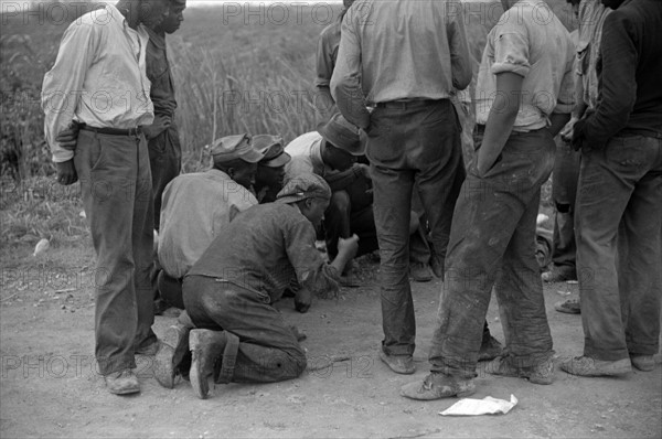 Vegetable workers, migrants, waiting after work to be paid. Near Homestead, Florida 19390101.