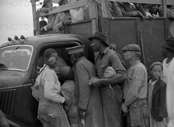 Untitled photo, possibly related to: Vegetable workers, migrants, waiting after work to be paid. Near Homestead, Florida By Russell Lee, 1903-1986, photographer Date 19390101.