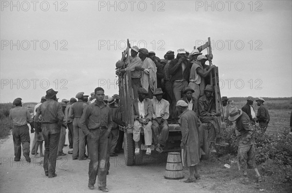 Vegetable workers, migrants, waiting after work to be paid. Near Homestead, Florida 19390101.