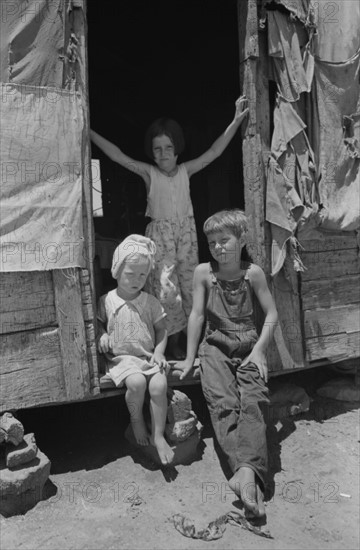Children of agricultural day labourer . The father, an oil field worker, had deserted the family. The shack was near Vian, Oklahoma 19390101