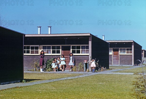 Families of migratory workers in front of their row shelters, 1942