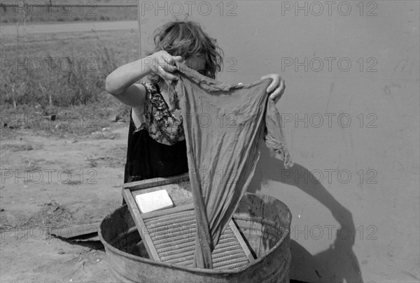 Twelve-year-old girl keeps house in trailer for her three brothers who are migrant workers, near Harlingen, 19390101