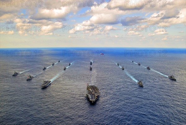 Photograph of Navy and Japan Maritime Self-Defence Force ships transit in formation at the conclusion of Keen Sword 15, a joint/bilateral field training exercise involving U.S. military and the Japan Self-Defence Force to increase combat readiness and interoperability