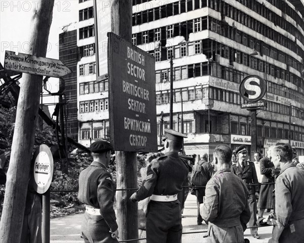 Photograph of British military police erecting a sign to mark division of the British and Russian sectors of Berlin