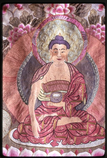 Photograph of a religious silk textile (thangka) depicting Buddha