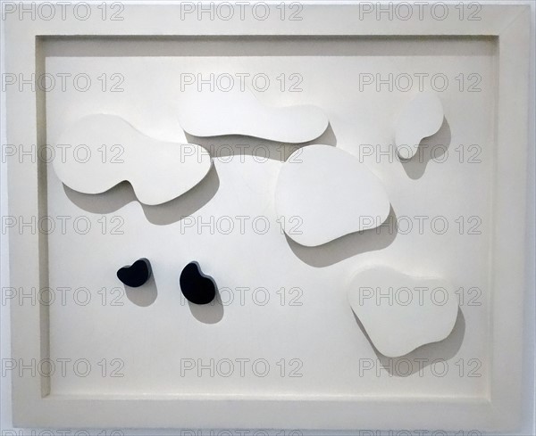 Constellation of five white shapes and two black shapes; 1932 Painted wood. By Jean Arp