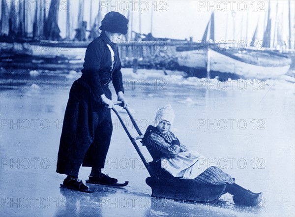 In Holland. Photo possibly shows boy and girl in Volendam