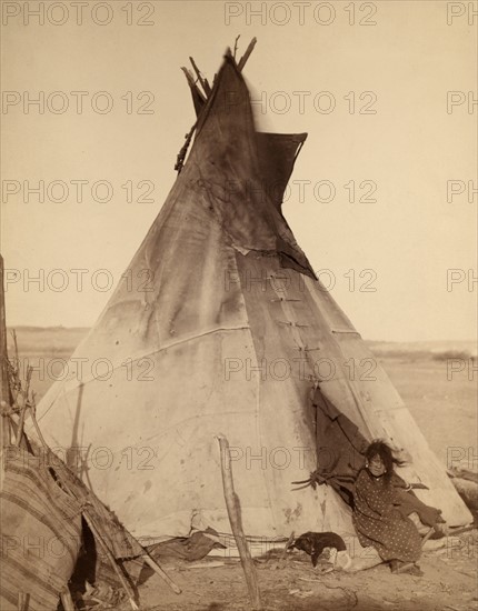 Photographic print of a young Oglala girl sitting in front of a Tipi