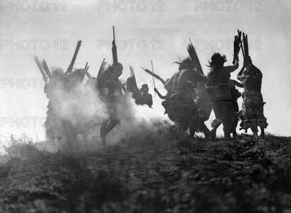 Photographic print of Kwakiutl people performing a ritualistic dance to restore an eclipsed moon