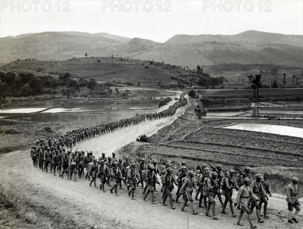 photographic print of Chinese soldiers marching on road in Burma Road heading toward the Salween front