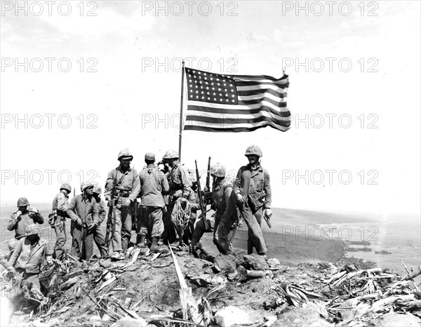 Battle of Iwo Jima. Photo taken during flag raising on volcano top.