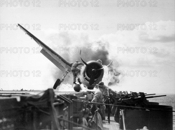 F6F Hellcat (VF-2) crash landed on USS Enterprise's flight deck. World War Two.