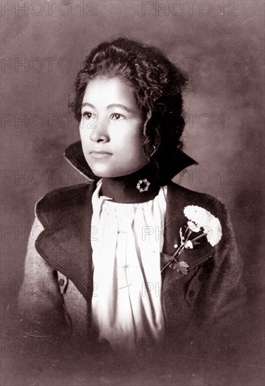 African American woman, head-and-shoulders portrait, facing left.