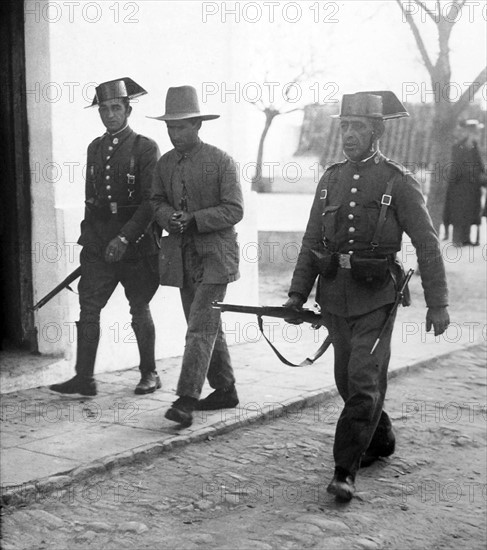 Peasant is arrested by Civil guards in Spain.