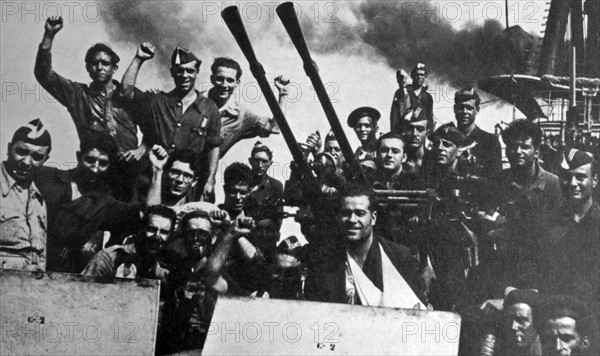 Jubilant sailors cheer on the Nationalist cruiser