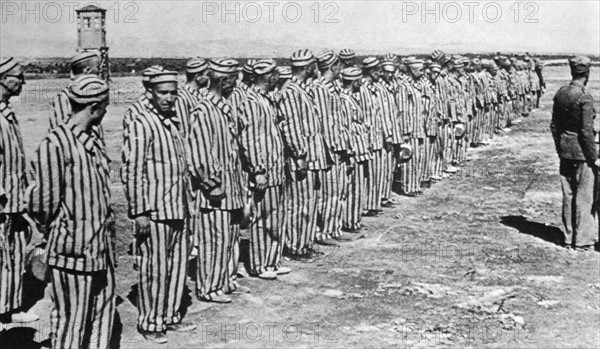 Prisoners in uniform, inside a Civil prison camp