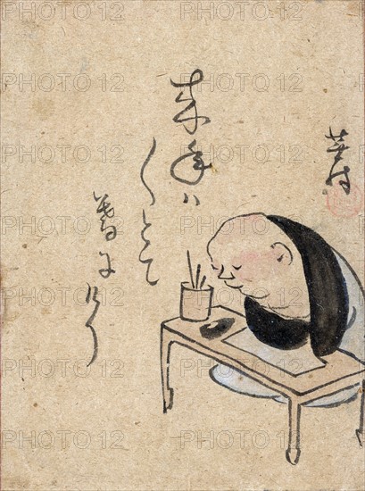 A man or monk seated at a table