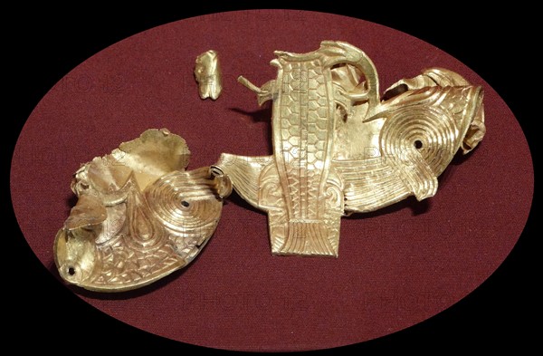 Plaque in the shape of two birds of prey and a fish