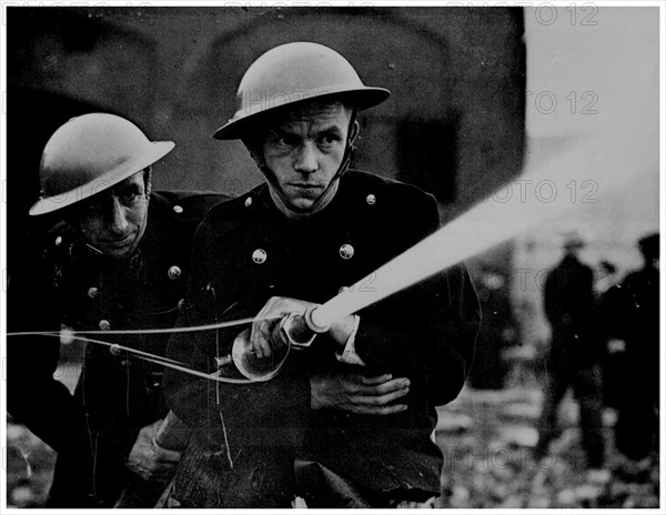 British firefighters in a bombed area in England, World War Two, 1943