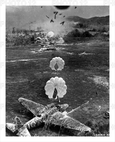 Photograph of a Mitsubishi Ki-21 under attack on airfield