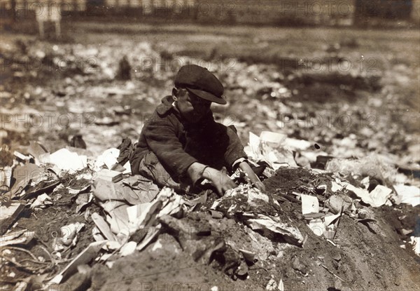 Photograph of a young scavenger going through the Trash on Pleasant Street dump