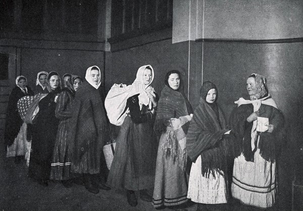 Immigrants arrive at US customs at Ellis Island, New York USA 1910