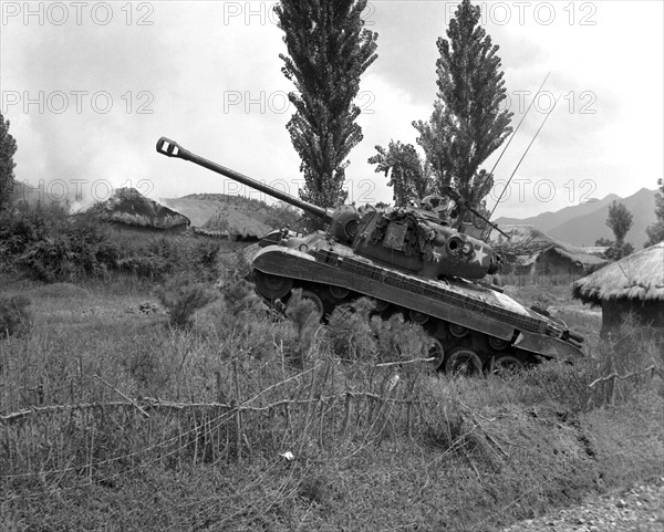 US Marine Corps Pershing tank at the edge of a village in Korea, 4 Sep 1950