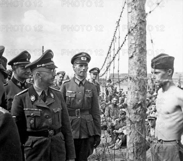 SS Chief Heinrich Himmler walks through a t prisoner of war camp for Russian prisoners of war.