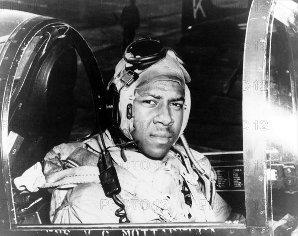 Photograph of Jesse L. Brown in the cockpit of a F4U-4 Corsair fighter