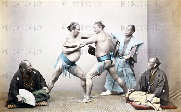 Hand-coloured photograph of Japanese sumo wrestlers by Felice Beato