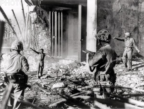 Photograph of Japanese soldiers surrendering to US soldiers,