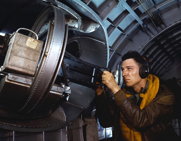 American airman using a a side machine gun of a B-17 Flying Fortress bomber