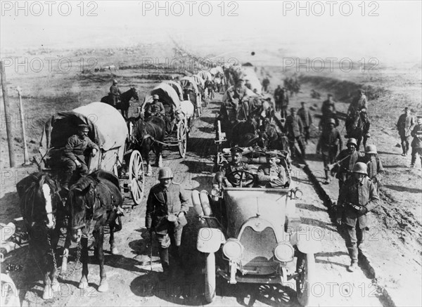 German officers in an automobile, with a convoy of wagons;World war one 1916