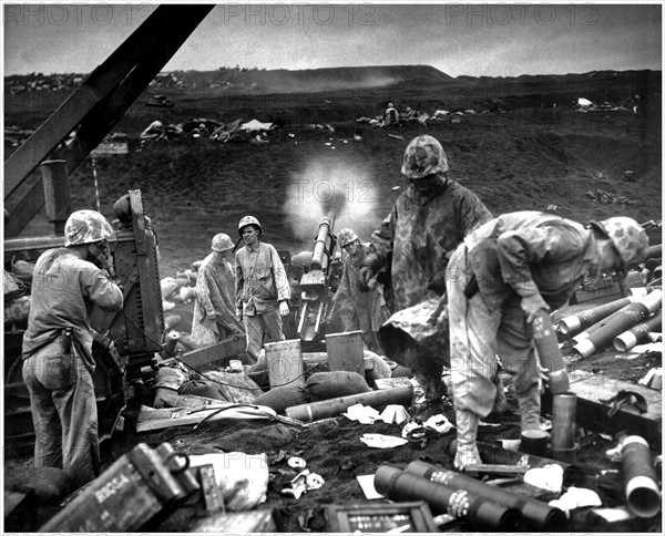 Photograph of Artillery pumps a stream of shells into Japanese positions