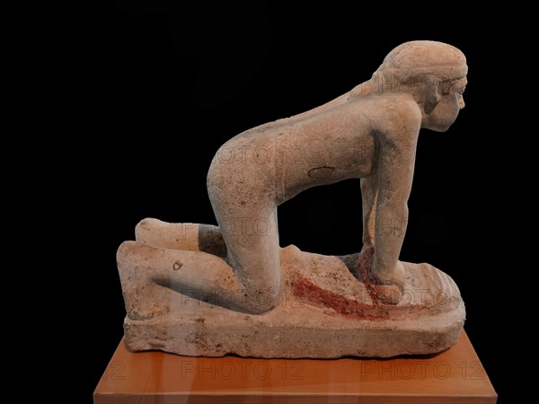 statue of a servant grinding crops. Limestone. Old Kingdom, 5th Dynasty (2465-2323 B.c.)