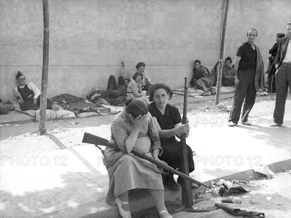 republicans women with rifles rest during a lull in the Spanish Civil War.