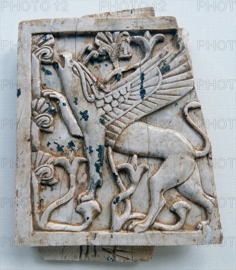 Ivory depicting a griffin eating leaves from a tree