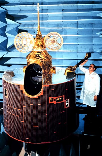 Scientist working on GOES-D model satellite