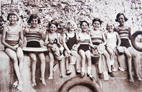 Children enjoying time at a beach in England