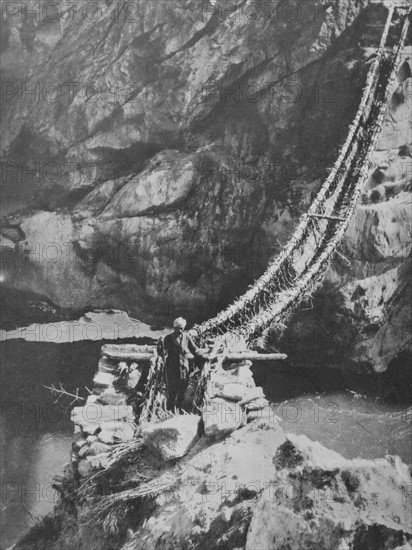 Rope bridge across a river in Kashmir India 1930