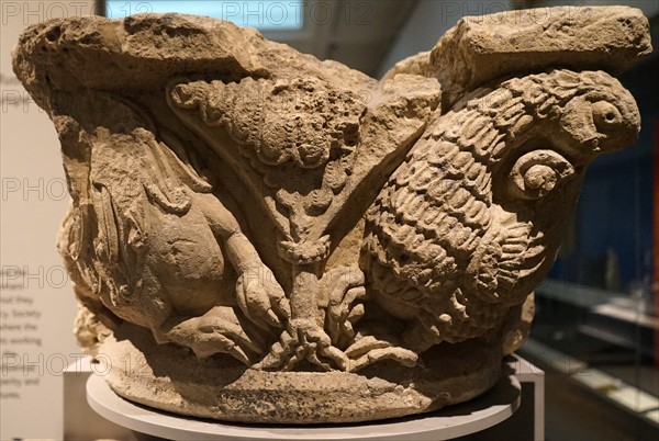 Stone capital with lion and griffin