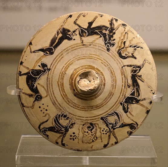 Lid from a pyxis with animals and a cuirass from Greece