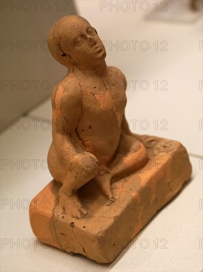 Terracotta figure of a squatting infant from the Archaic period