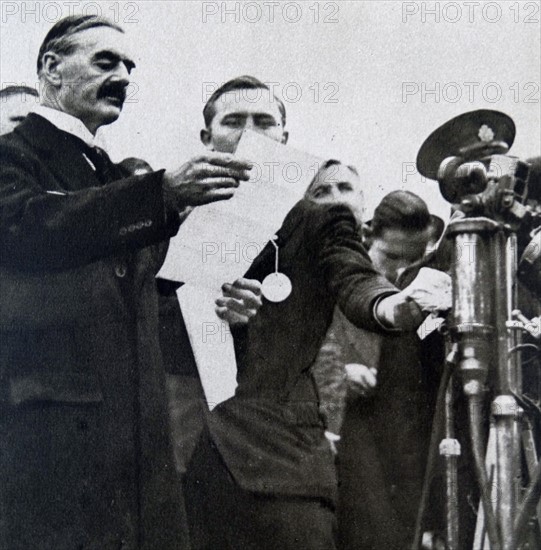 Prime Minister Neville Chamberlain reading his and Adolf Hitler’s Joint Resolution 'Never to Go to War with One Another Again'