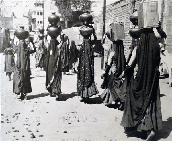 barefoot Chuddar-draped Water Bearers Trudging Homeward in a Burning Sun