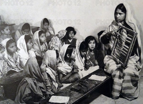 a teacher demonstrating to students how to count with an abacus