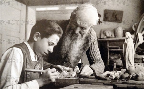 a young Oberammergau Wood-carving Student Manicuring a Wooden Lady