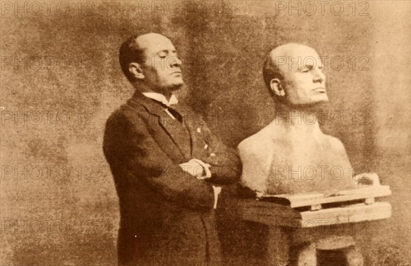 Benito Mussolini posing for his bust